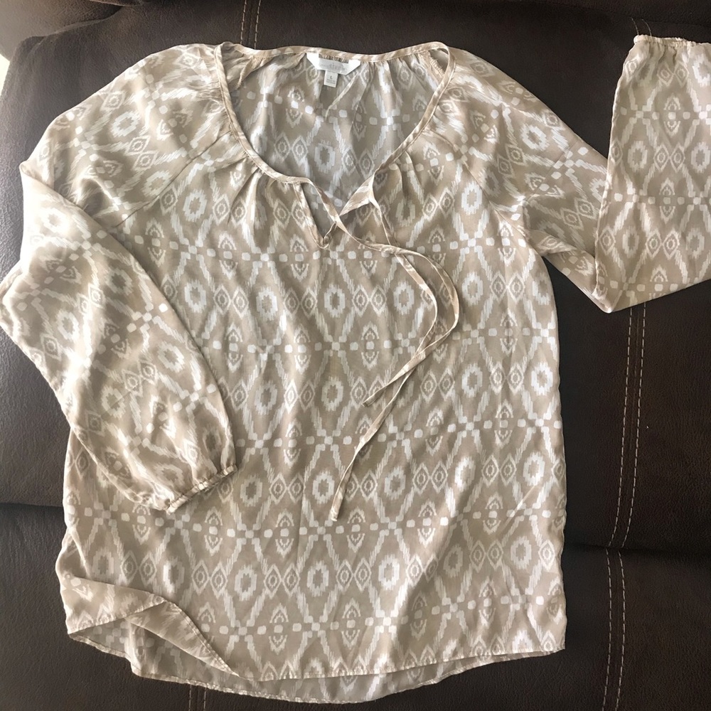 Sheer beige and white top.